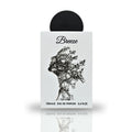 A close-up view of the Breeze Eau De Parfum bottle by Lattafa Pride, featuring an artistic design of a silhouette intertwined with branches on a sleek white surface.